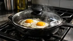Use an ice cube to stop oil splatter when frying eggs